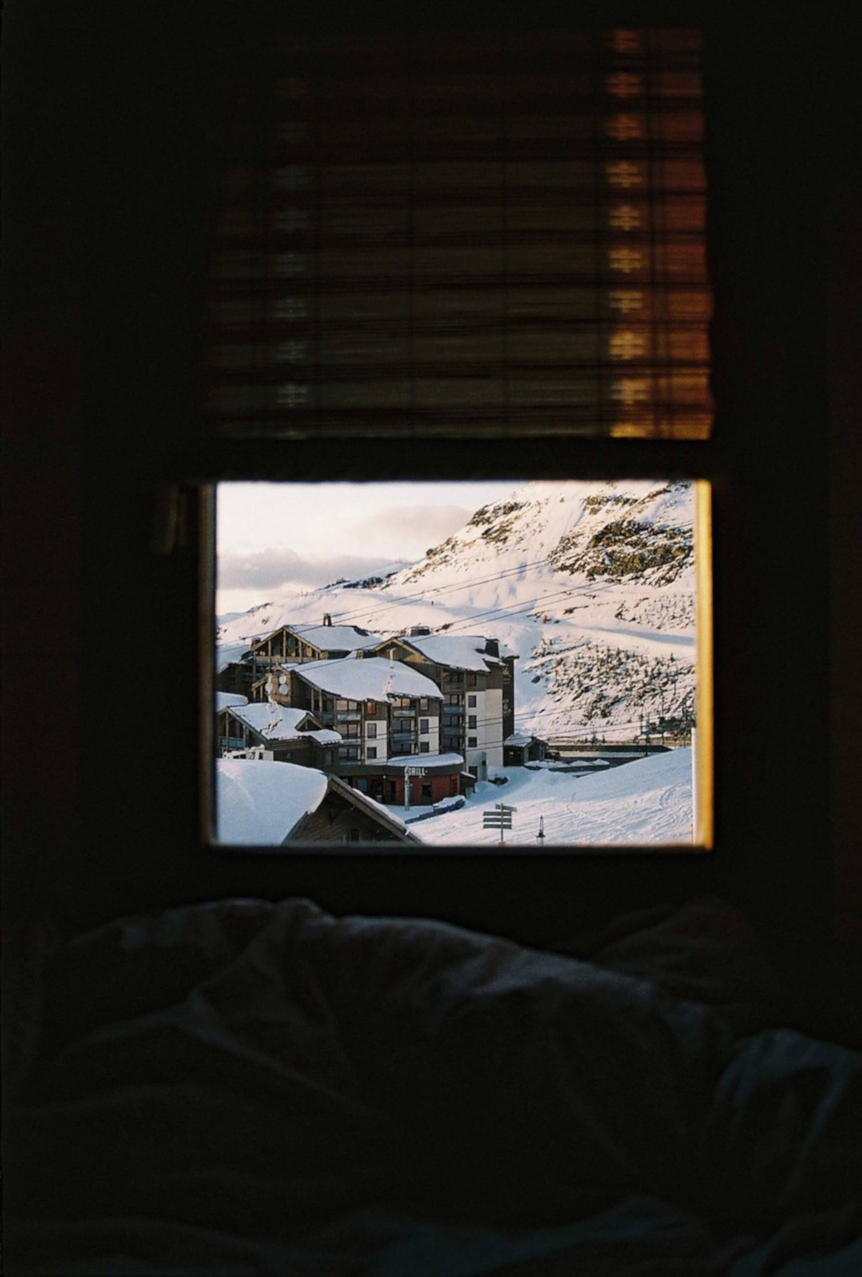 An image of a snowy landscape through a window